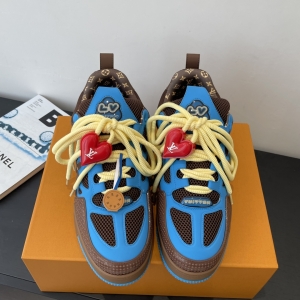 The LV Trainer Sneaker features a blue upper with brown trim and white laces.