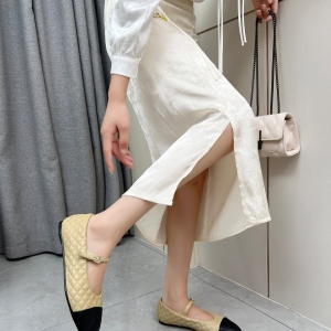 Chanel-style beige and black diamond-patterned Mary Jane flats